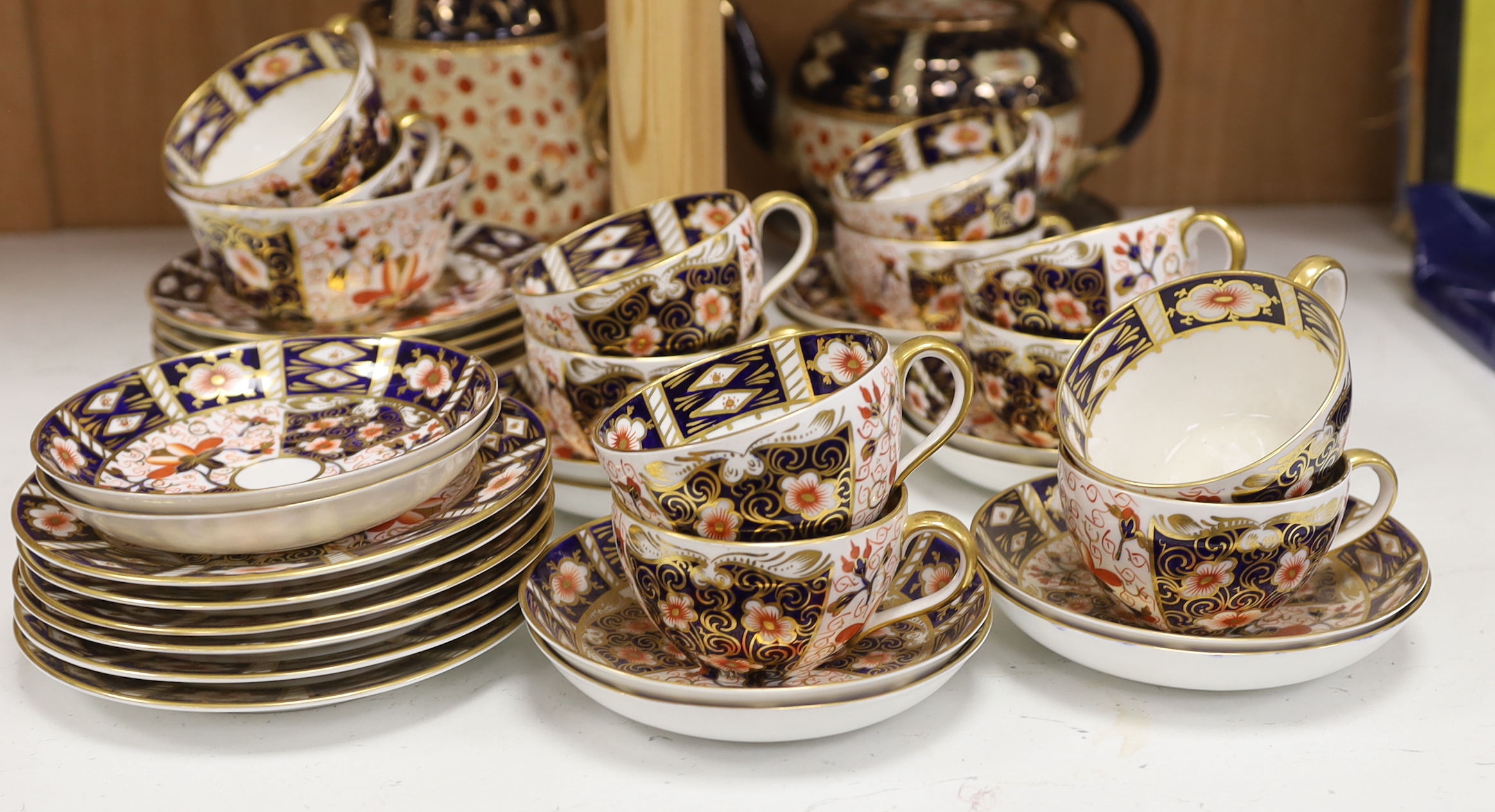 A Royal Crown Derby Imari pattern 2451 part tea set together with an Imari style jug, teapot and stand, largest 18cm high